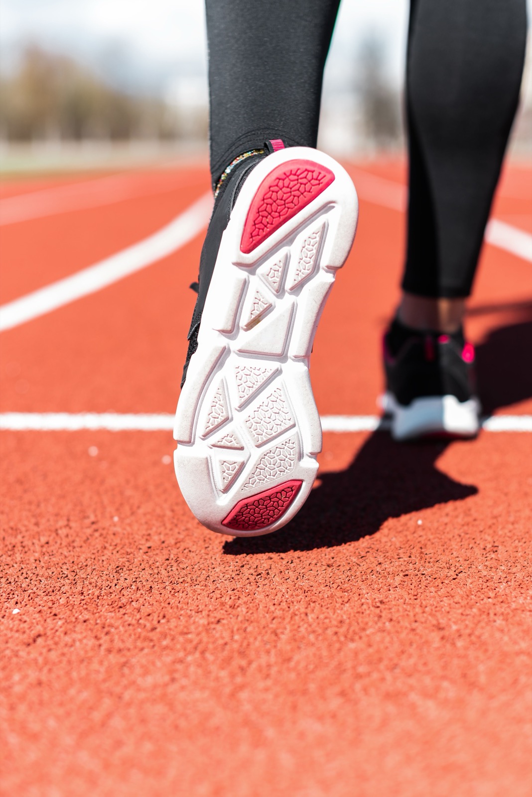Close-up of a running shoe sole on an athletic track